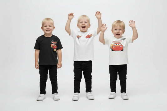 Four children wearing matching outfits with car-themed designs on a white background