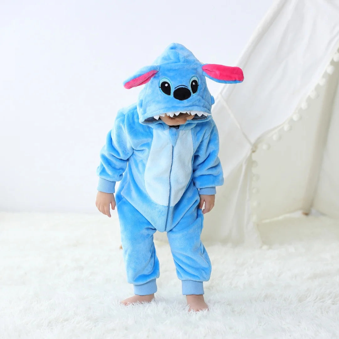 Child wearing a blue cartoon character onesie on a white background