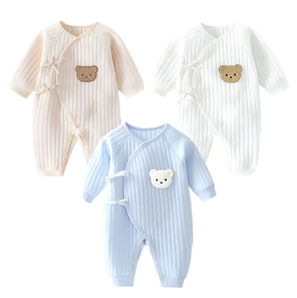 Three baby rompers with bear designs on a white background