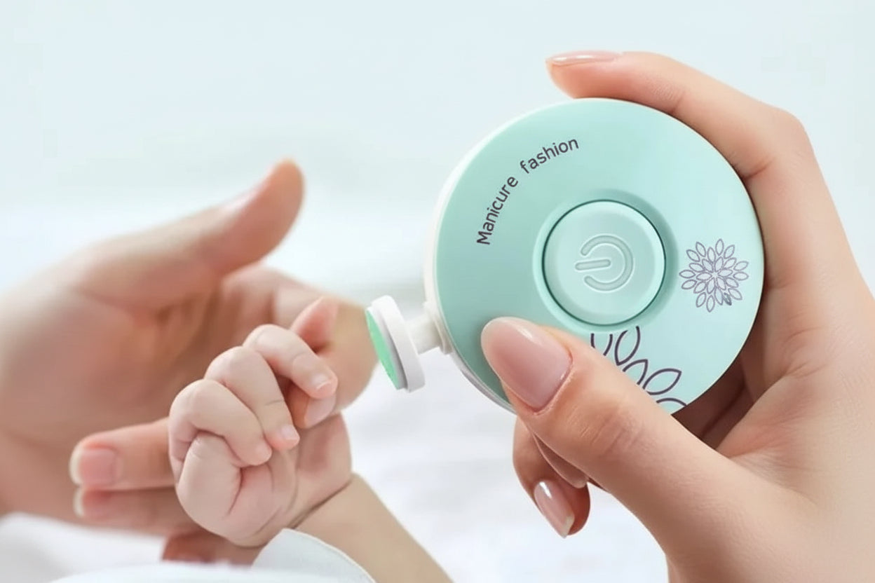 Baby's hand held by an adult hand with a nail clipper labeled 'Manicure fashion' on a light background.